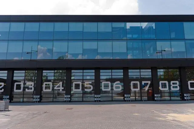 porte industrielle dans d’une Lagerhalle avec nachgerüsteter barrière photoélectrique, rideau lumineux, sécurité de bord de fermeture et sicherer Verkabelung pour einen zuverlässigen Torbetrieb.
